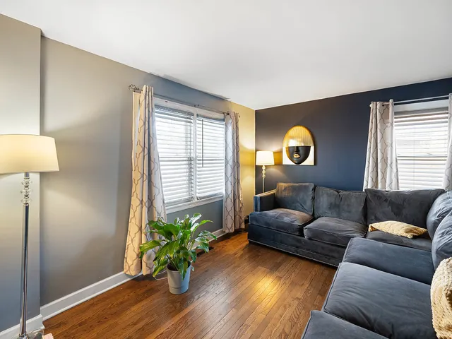 a living room with furniture and a lamp