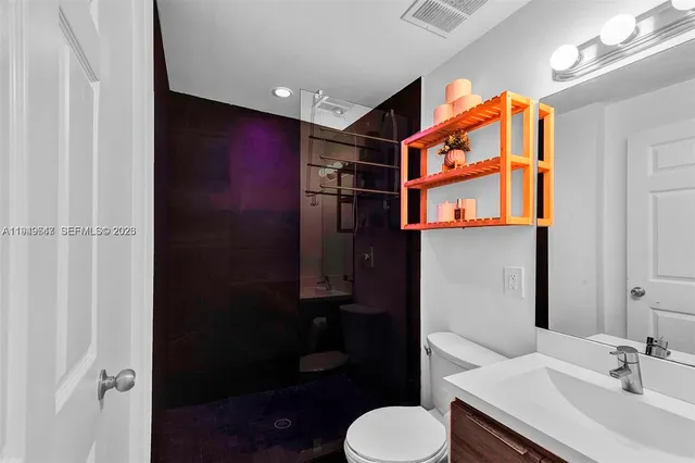 a bathroom with a sink toilet and shower