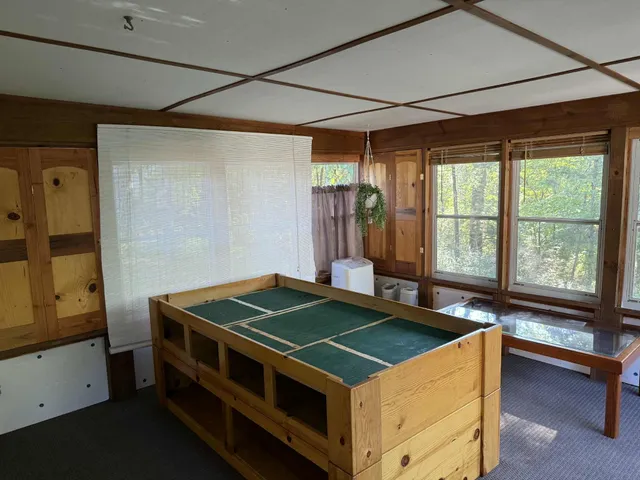 a room with pool table and windows