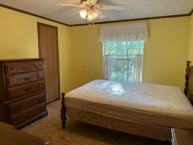 a bedroom with a bed and a window