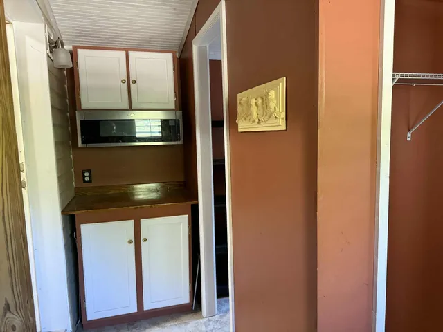 a view of a livingroom with furniture and staircase