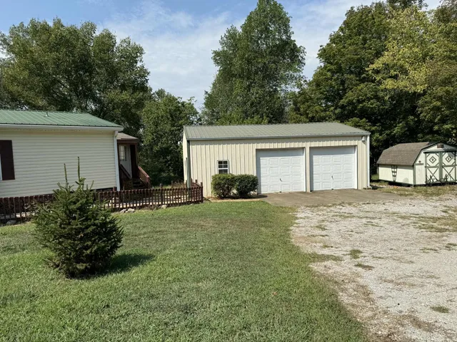a house with green field in front of it