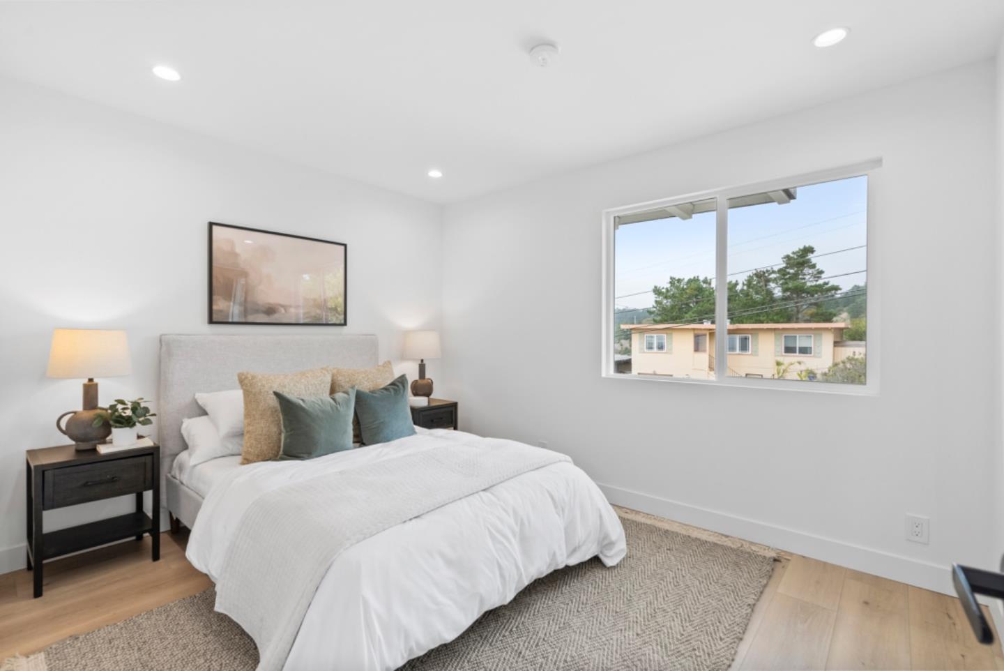 444 Manor Drive Pacifica, CA 94044 - Photo 16 of 70 a bedroom with a bed and a painting on the wall