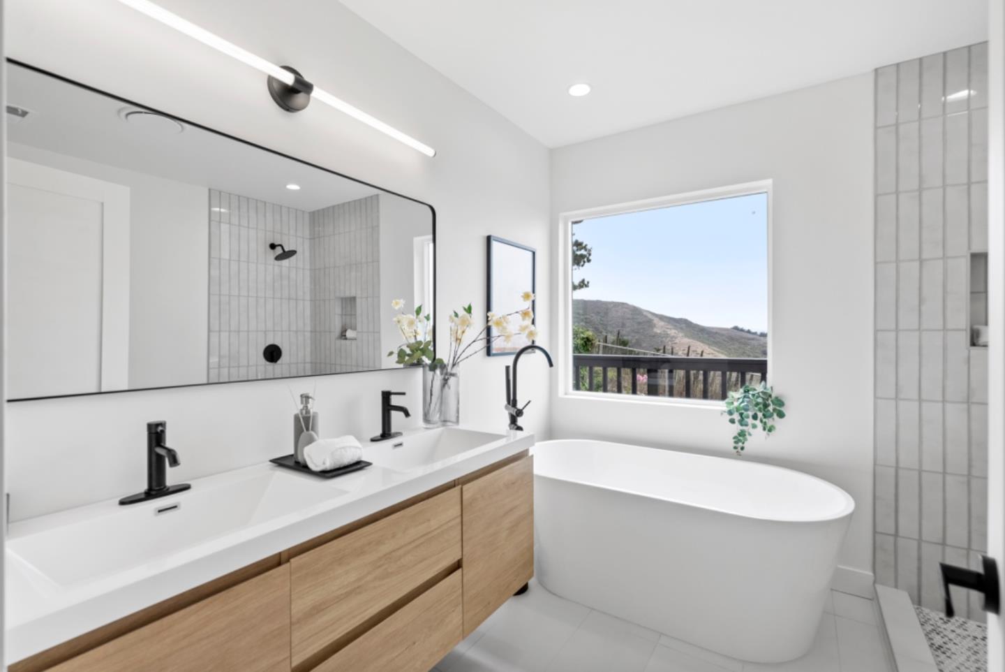 444 Manor Drive Pacifica, CA 94044 - Photo 19 of 70 a bathroom with a double vanity sink a mirror and a bathtub