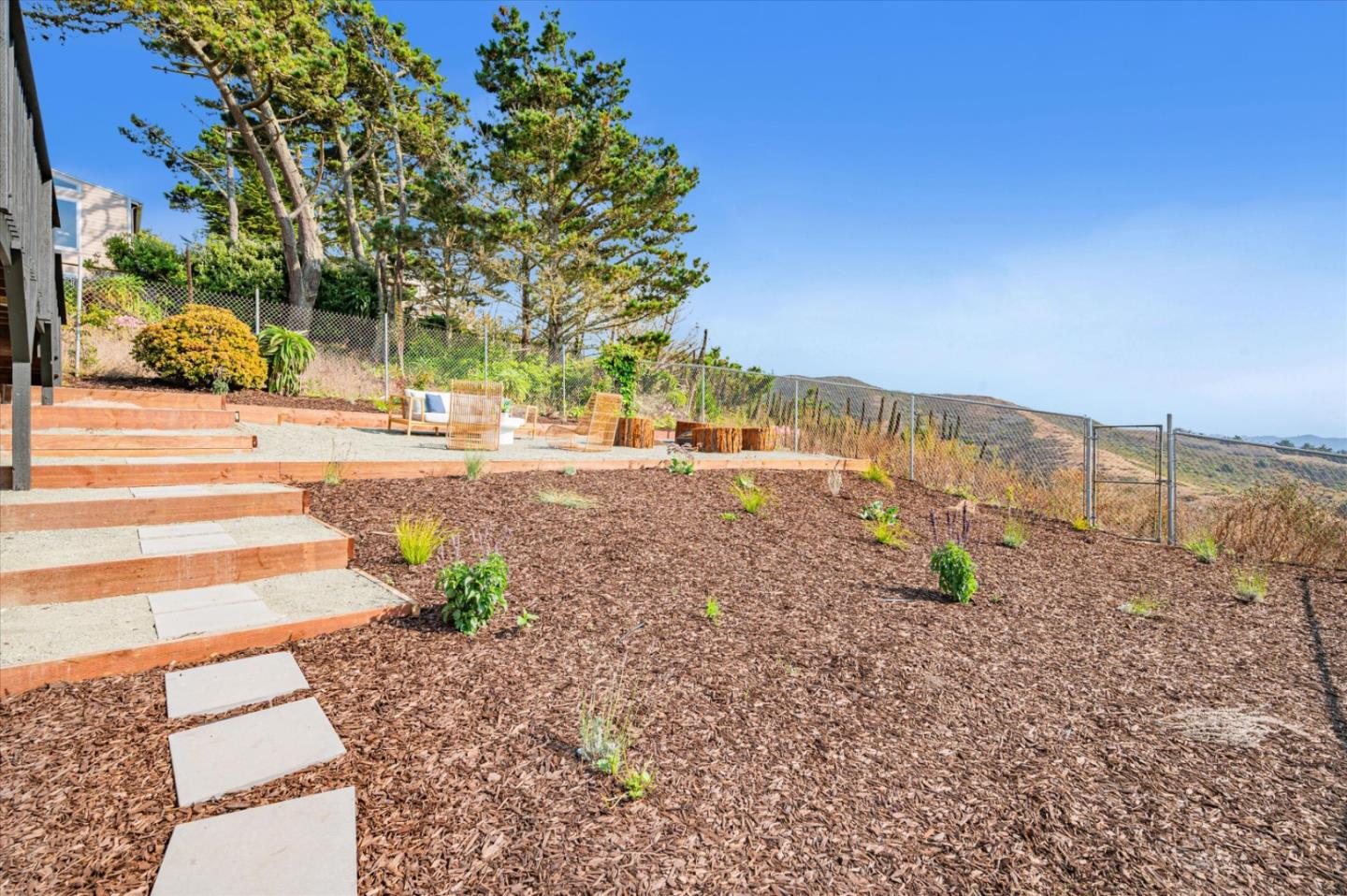 444 Manor Drive Pacifica, CA 94044 - Photo 68 of 70 a view of a yard with plants and a bench