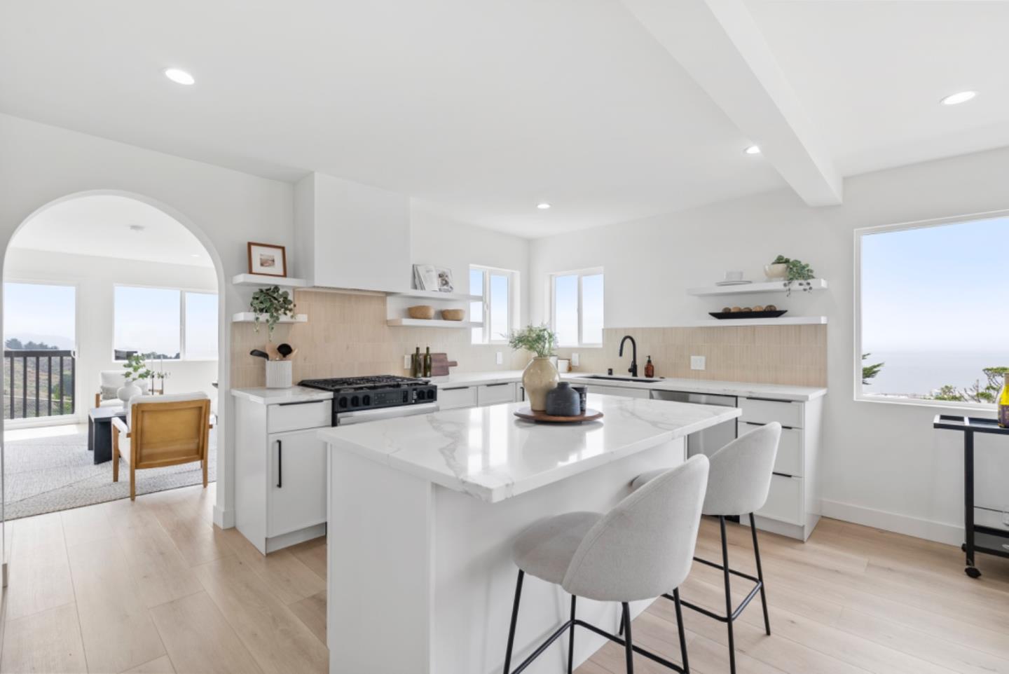 444 Manor Drive Pacifica, CA 94044 - Photo 7 of 70 a kitchen with stainless steel appliances a stove a sink a refrigerator white cabinets and couches with wooden floor