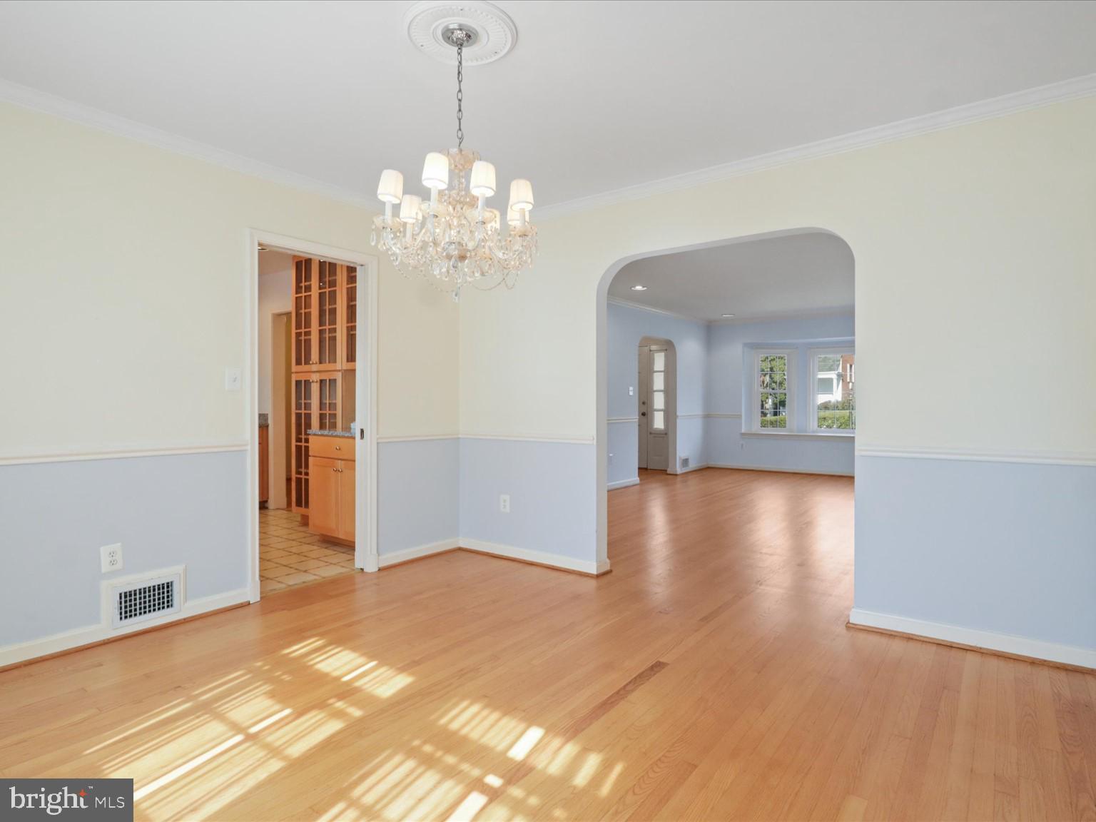 1002 Beverley Drive Alexandria, VA 22302 - Photo 11 of 46 a view of a hallway with wooden floor and a chandelier