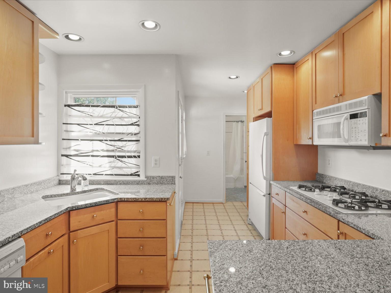 1002 Beverley Drive Alexandria, VA 22302 - Photo 15 of 46 a kitchen with stainless steel appliances granite countertop a sink stove and refrigerator