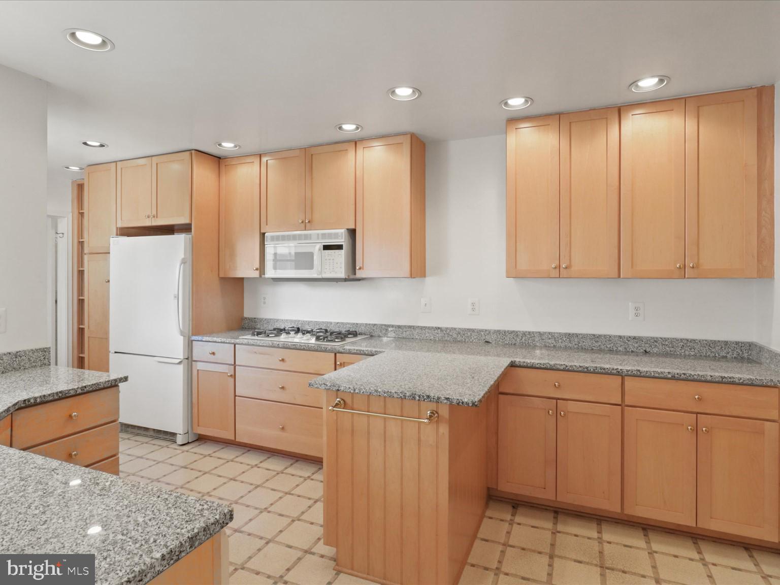 1002 Beverley Drive Alexandria, VA 22302 - Photo 16 of 46 a kitchen with a sink a stove cabinets and counter space