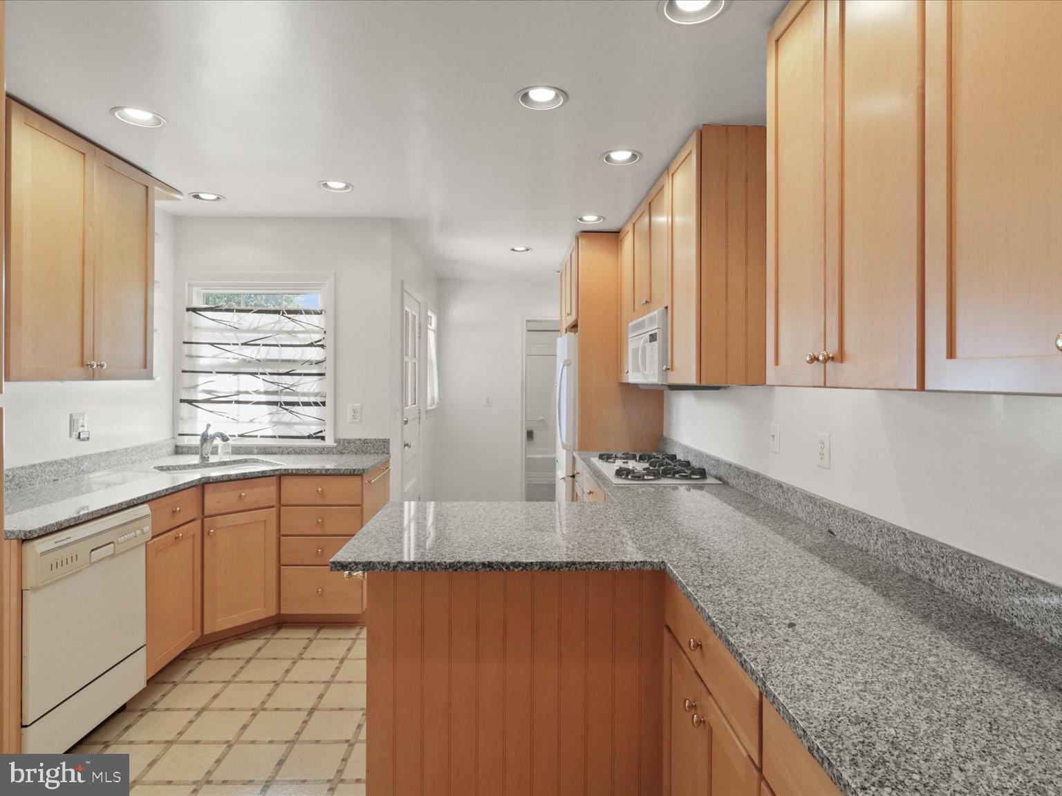 1002 Beverley Drive Alexandria, VA 22302 - Photo 17 of 46 a kitchen with stainless steel appliances granite countertop a sink stove and cabinets