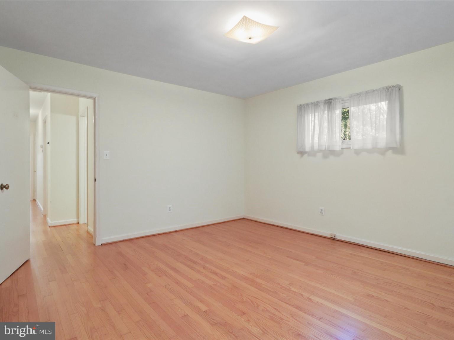 1002 Beverley Drive Alexandria, VA 22302 - Photo 25 of 46 an empty room with wooden floor and windows