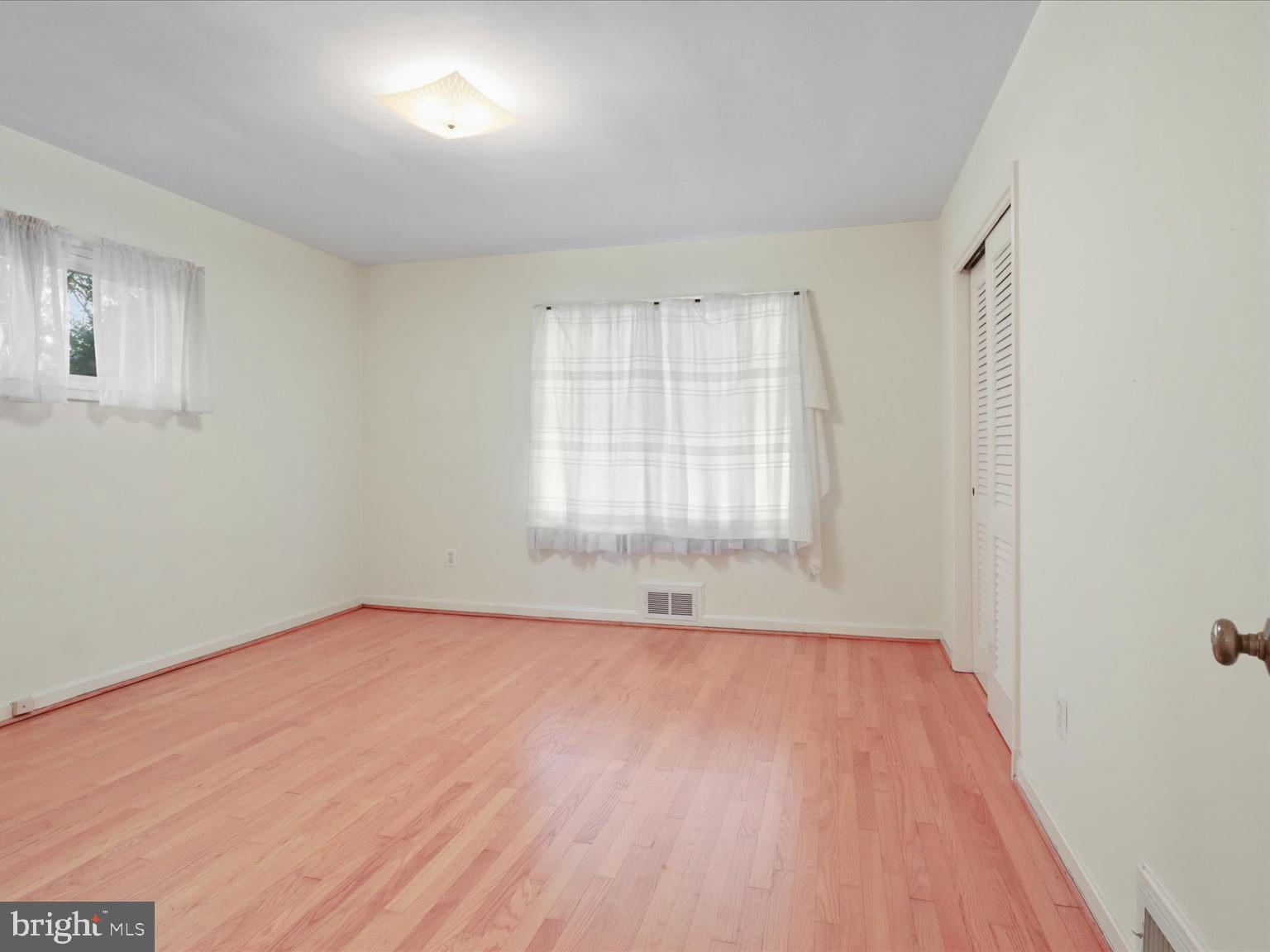 1002 Beverley Drive Alexandria, VA 22302 - Photo 26 of 46 an empty room with wooden floor and windows