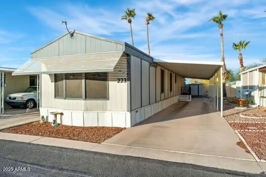 10220 East Apache Trail, Unit 223 Apache Junction, AZ 85120 - Photo 1 of 18 a front view of a house with a garden