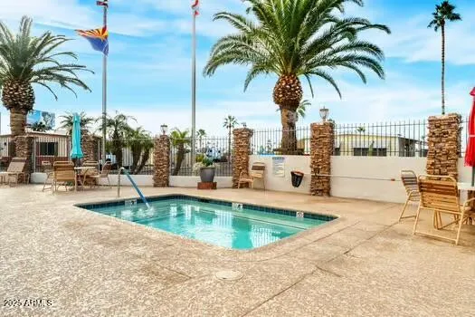 a view of a swimming pool with a lawn chairs and swimming pool