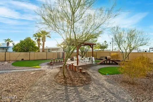 a view of a backyard with swimming pool