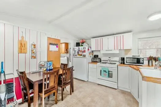 a kitchen with stainless steel appliances granite countertop a stove a sink dishwasher and a refrigerator with wooden cabinets