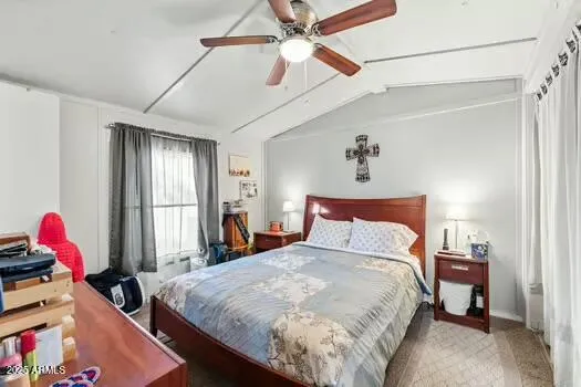a bedroom with bed and a chandelier