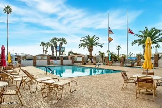 a view of a swimming pool with outdoor seating