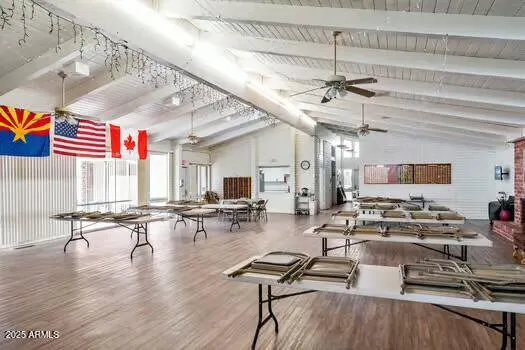 a room with lots of chairs and lots of wooden furniture