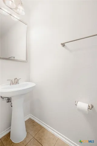 a bathroom with a sink a toilet and mirror