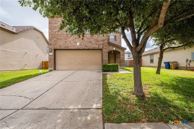 a front view of house with yard and green space