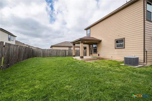 a backyard of a house with table and chairs