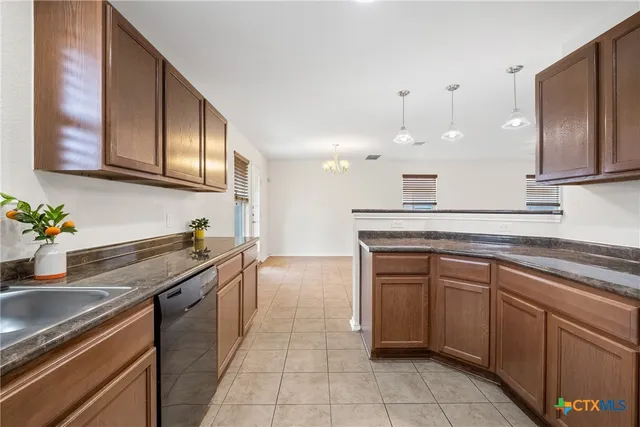a kitchen with stainless steel appliances granite countertop a sink and cabinets