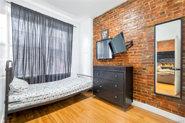 a bedroom with a bed and a television