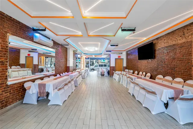 a large room with lots of wooden furniture and a chandelier