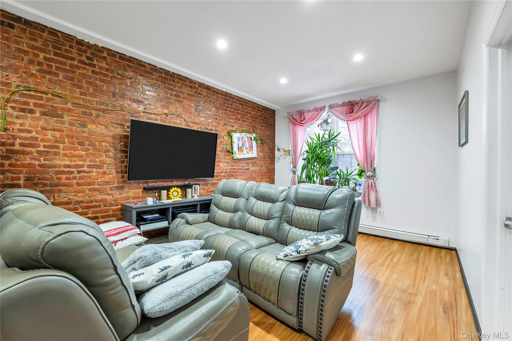 91-08 43rd Avenue Queens, NY 11373 - Photo 10 of 17 a living room with furniture and a flat screen tv