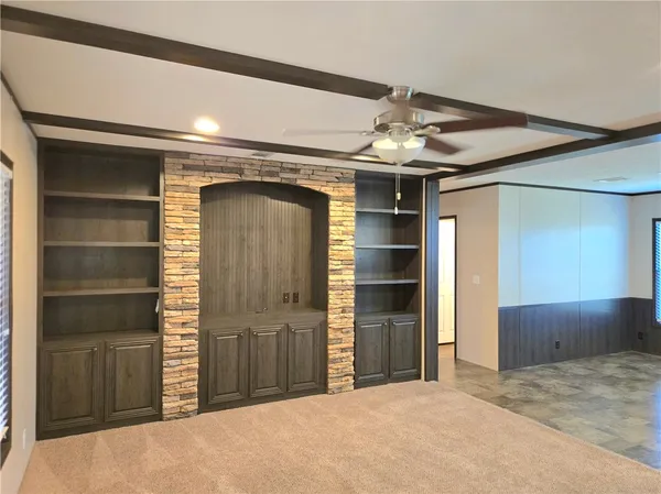 a view of a hallway with wooden shelves