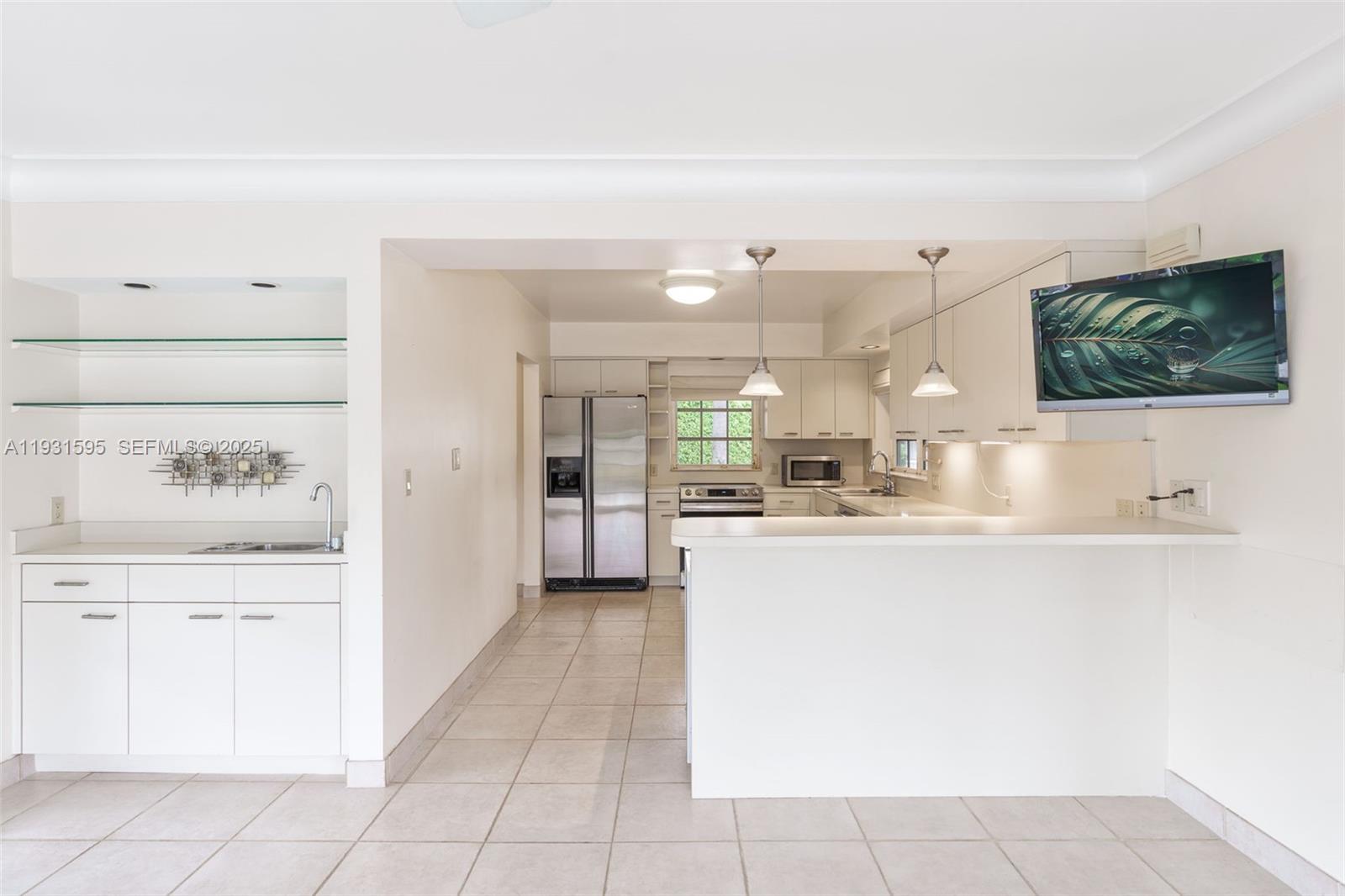 2130 Northeast 15th Street Fort Lauderdale, FL 33304 - Photo 15 of 32 a kitchen with a sink and cabinets