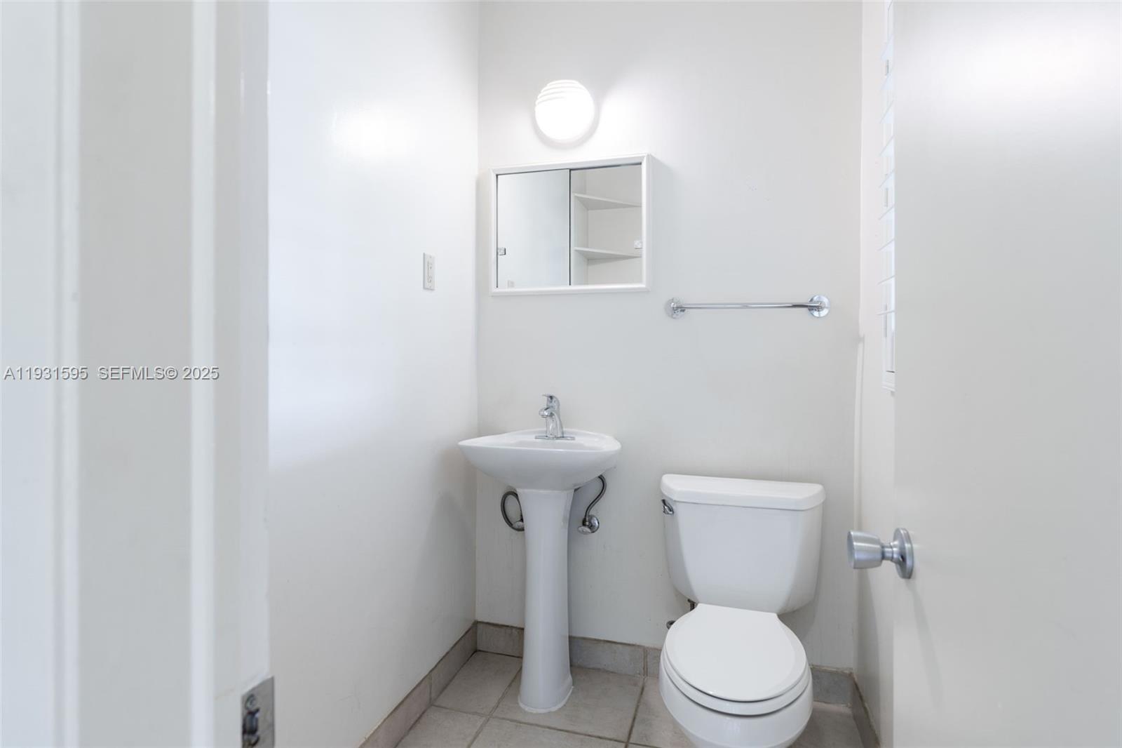 2130 Northeast 15th Street Fort Lauderdale, FL 33304 - Photo 20 of 32 a white toilet sitting next to a bathroom sink