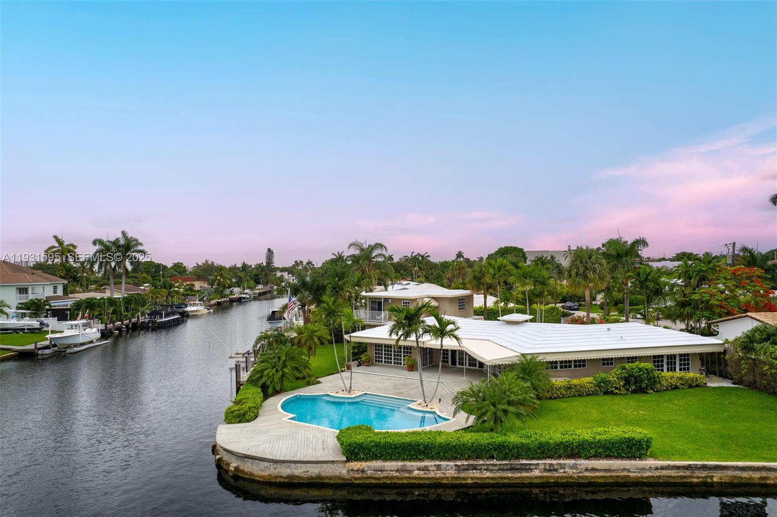 2130 Northeast 15th Street Fort Lauderdale, FL 33304 - Photo 2 of 32 a view of a lake with a yard and mountain view