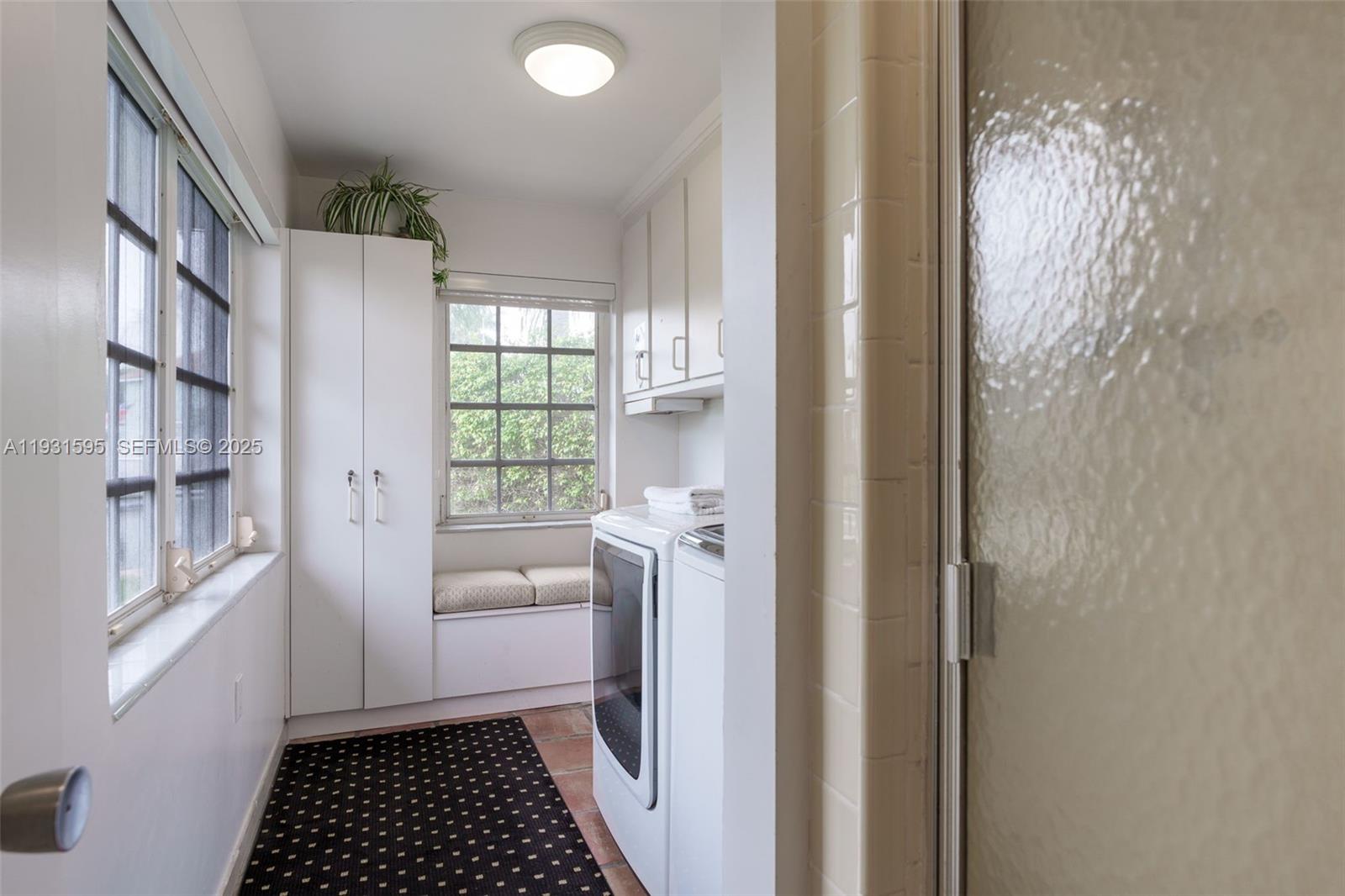 2130 Northeast 15th Street Fort Lauderdale, FL 33304 - Photo 23 of 32 a room with a window and a white door