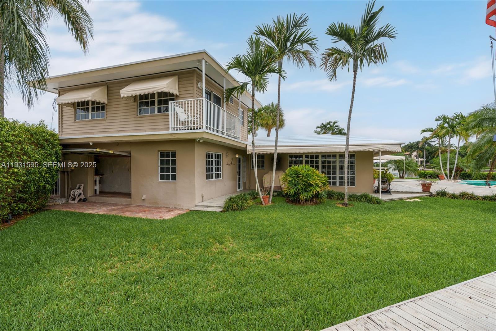 2130 Northeast 15th Street Fort Lauderdale, FL 33304 - Photo 30 of 32 a front view of a house with a garden and yard