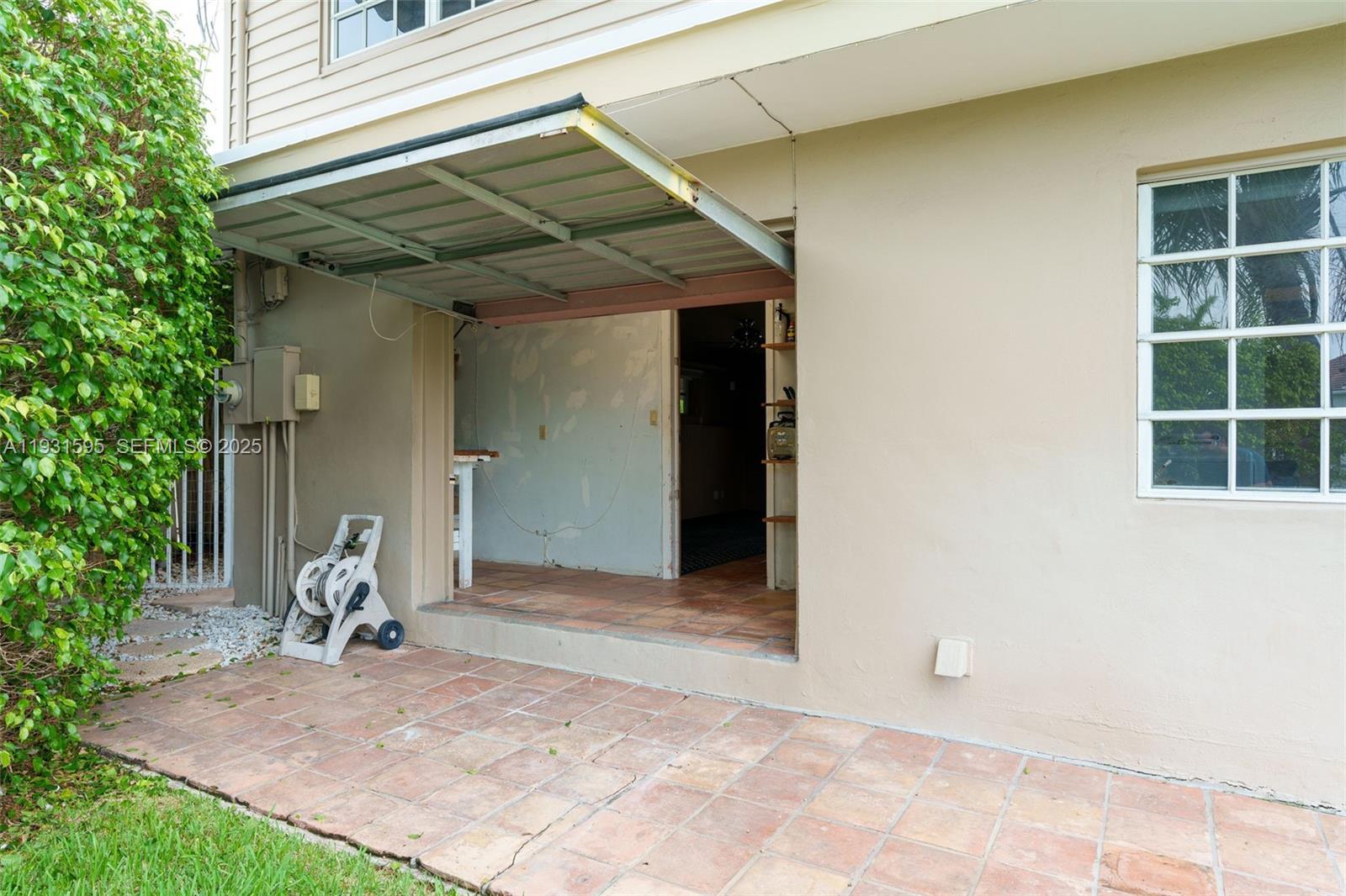 2130 Northeast 15th Street Fort Lauderdale, FL 33304 - Photo 31 of 32 a view of a backyard with table and chairs and a barbeque