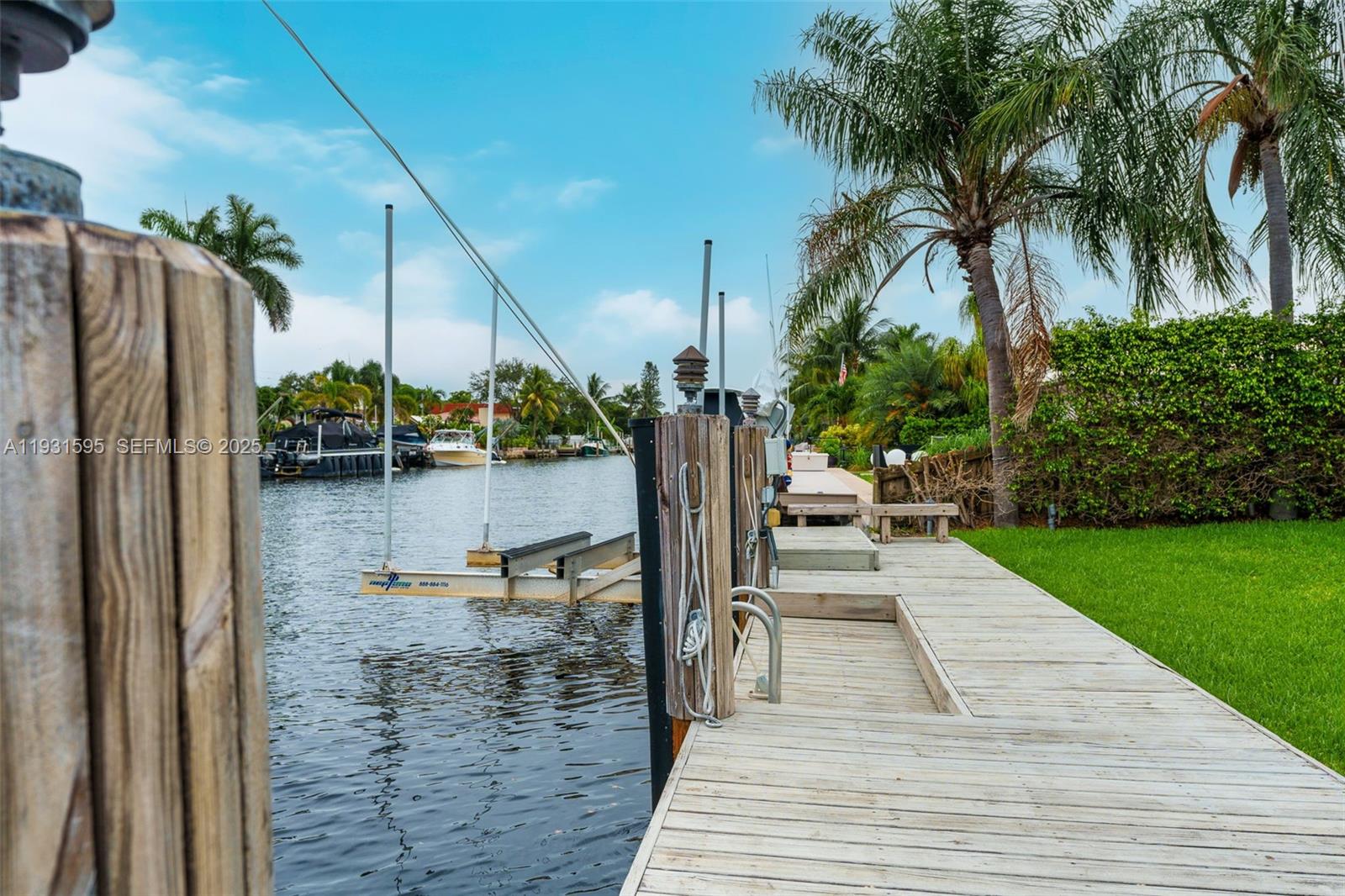 2130 Northeast 15th Street Fort Lauderdale, FL 33304 - Photo 32 of 32 a view of a patio with table and chairs potted plants with wooden floor
