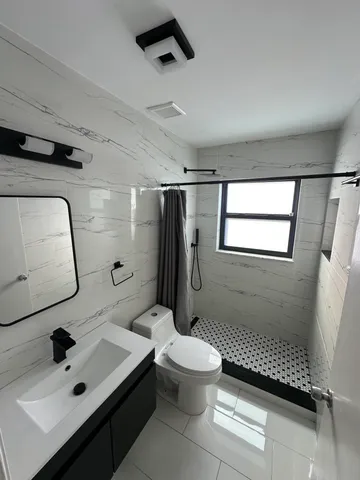 a bathroom with a sink toilet and shower