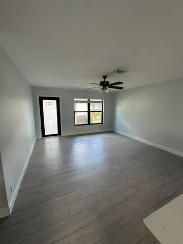 wooden floor in an empty room with a window