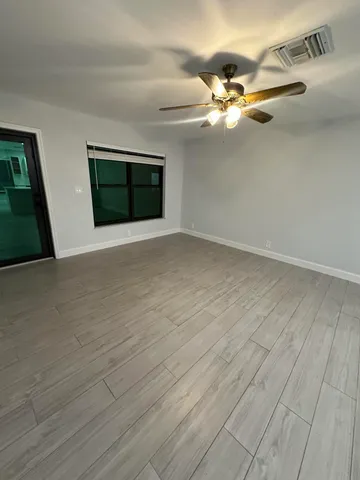 a view of a livingroom with a ceiling fan and window