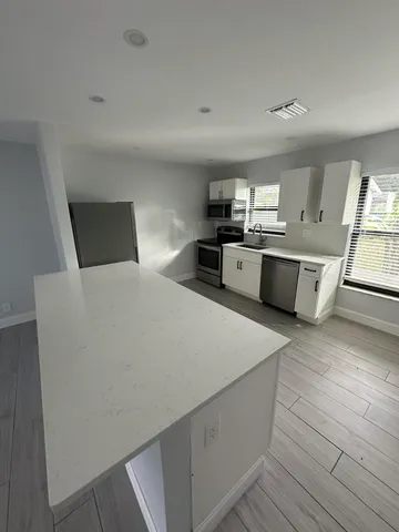 a large white room with kitchen island
