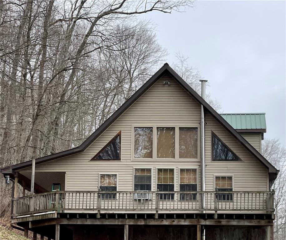34030 State Rte 27 Guys Mills, PA 16327 - Photo 2 of 21 a view of house with large windows and a wooden deck