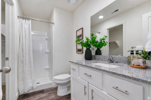 445 950 South Ogden, UT 84404 - Photo 20 of 28 Full bath with a shower stall, vanity, and dark wood-type flooring