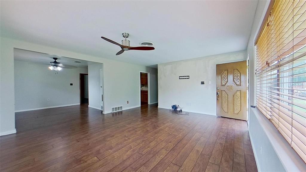900 Silver Creek Azle Road Azle, TX 76020 - Photo 7 of 27 Spacious interior featuring wood-finish flooring, a decorative entry door, and a modern ceiling fan