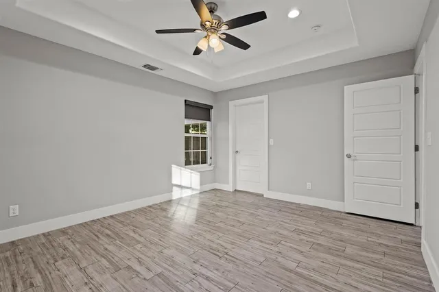 wooden floor in an empty room with a window