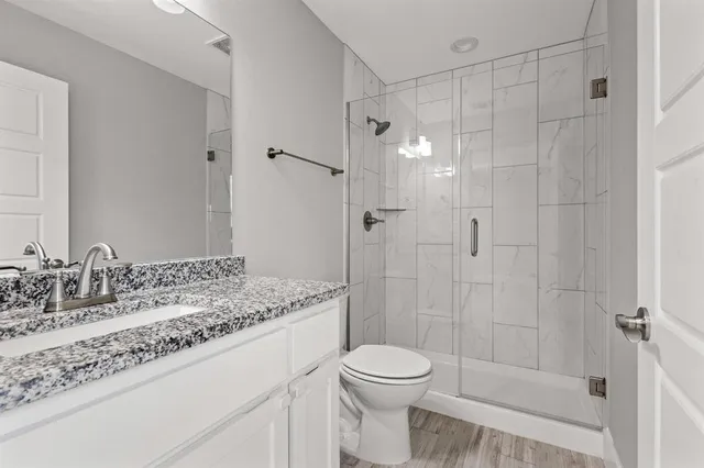 a bathroom with a sink toilet and shower