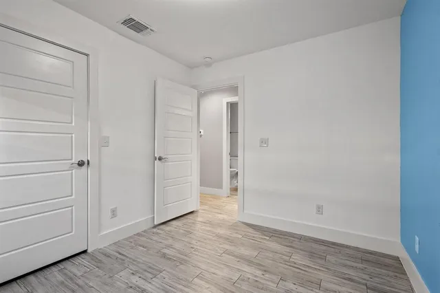 a view of an empty room and wooden floor