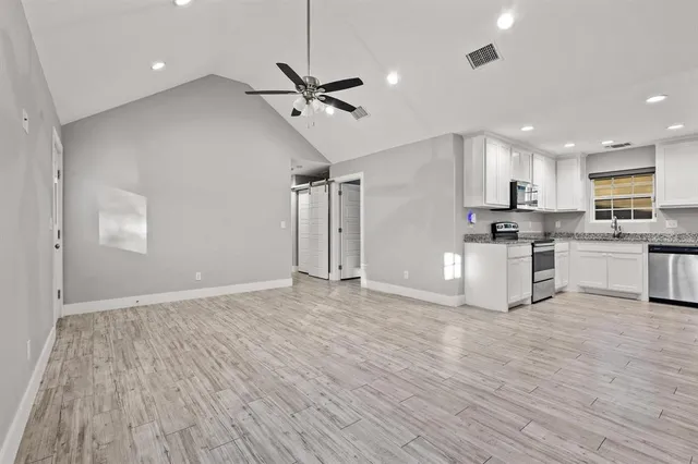 a view of kitchen with refrigerator microwave and wooden floor