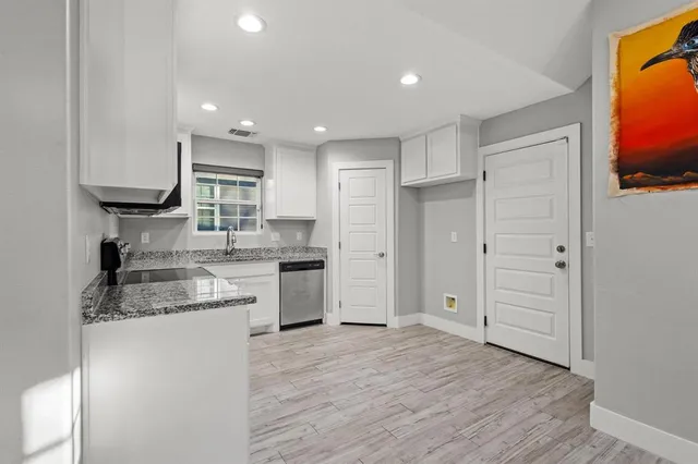a kitchen with stainless steel appliances granite countertop a refrigerator and a sink